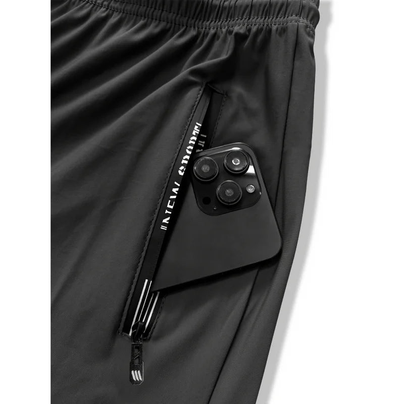 Pantalon de jogging homme, idéal pour la pêche. Modèle en soie glacée extensible avec poches zippées. Pantalon de sport respirant et élastique. Idée cadeau pour homme.