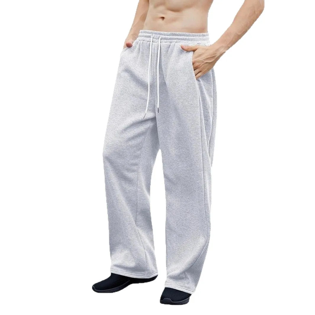 Pantalon de jogging pour homme, coupe droite, idéal pour le sport et la mode urbaine. Pantalon ample et décontracté avec cordon de serrage et plusieurs poches.
