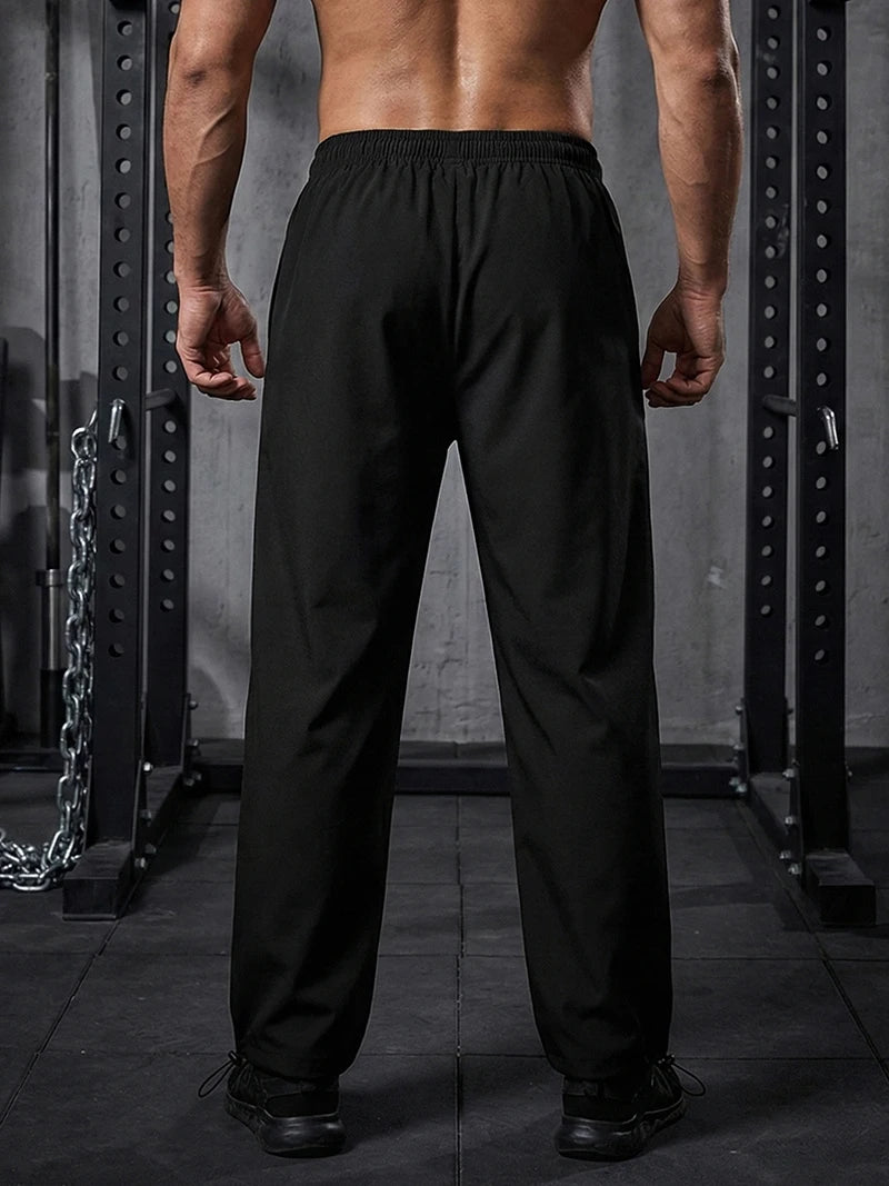 Pantalon de sport tendance pour homme, avec lignes, idéal pour la salle de sport et la course à pied. Poches latérales, séchage rapide et respirant.