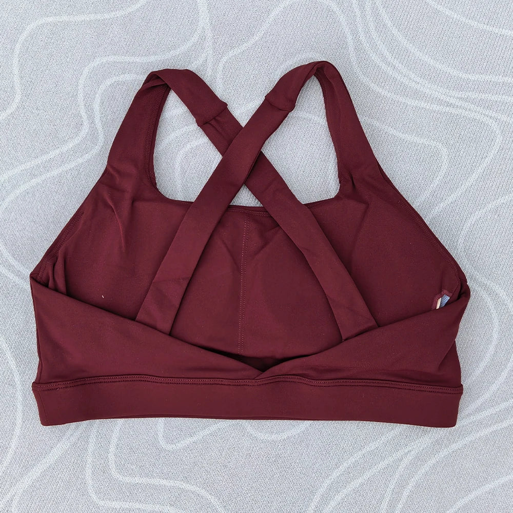 Soutien-gorge de sport et de fitness femme, couleur unie, moulant, dos croisé, idéal pour le yoga et la gym. Haut de sport avec dos ajouré et coussinets push-up.