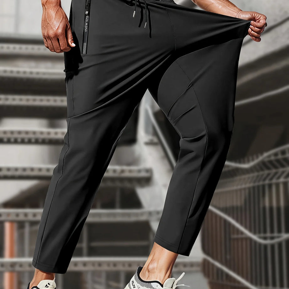 Pantalon de jogging homme, idéal pour la pêche. Modèle en soie glacée extensible avec poches zippées. Pantalon de sport respirant et élastique. Idée cadeau pour homme.
