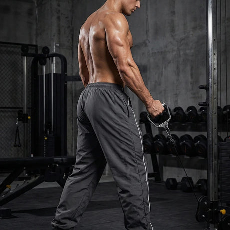 Pantalon de sport tendance pour homme, avec lignes, idéal pour la salle de sport et la course à pied. Poches latérales, séchage rapide et respirant.