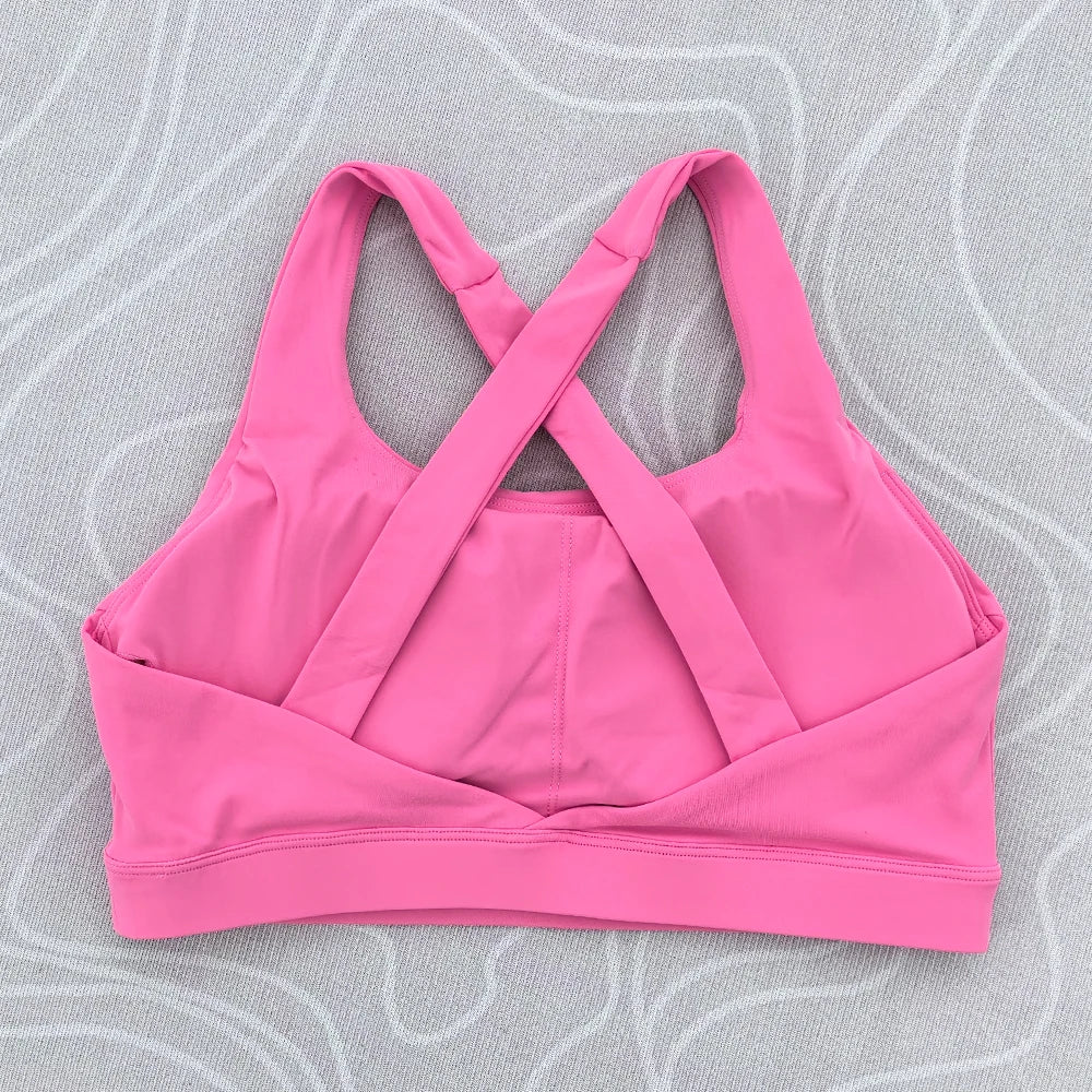 Soutien-gorge de sport et de fitness femme, couleur unie, moulant, dos croisé, idéal pour le yoga et la gym. Haut de sport avec dos ajouré et coussinets push-up.