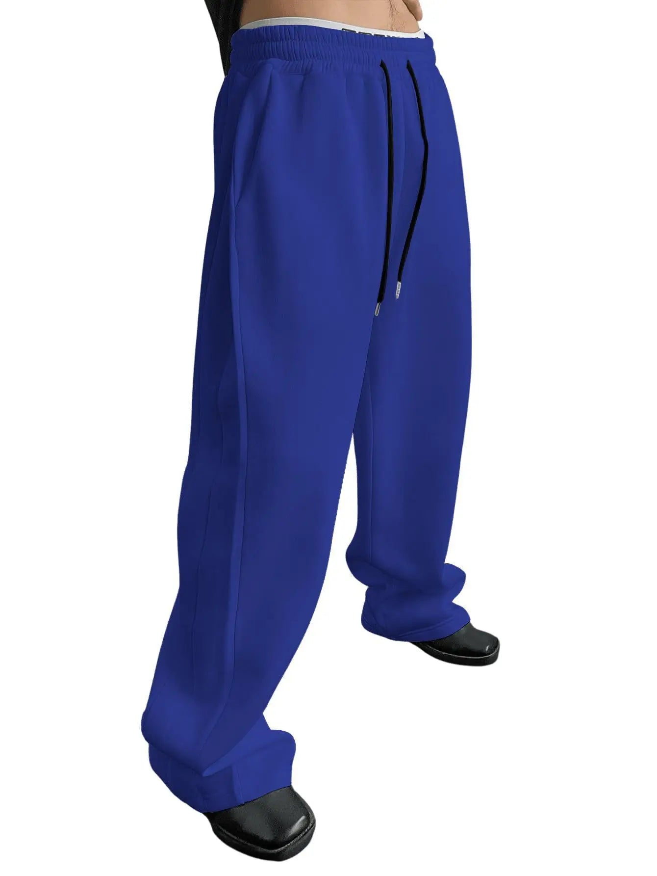 Pantalon de jogging pour homme, coupe droite, idéal pour le sport et la mode urbaine. Pantalon ample et décontracté avec cordon de serrage et plusieurs poches.