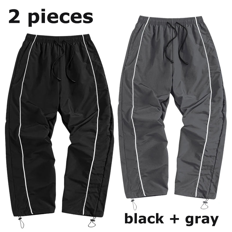 Pantalon de sport tendance pour homme, avec lignes, idéal pour la salle de sport et la course à pied. Poches latérales, séchage rapide et respirant.