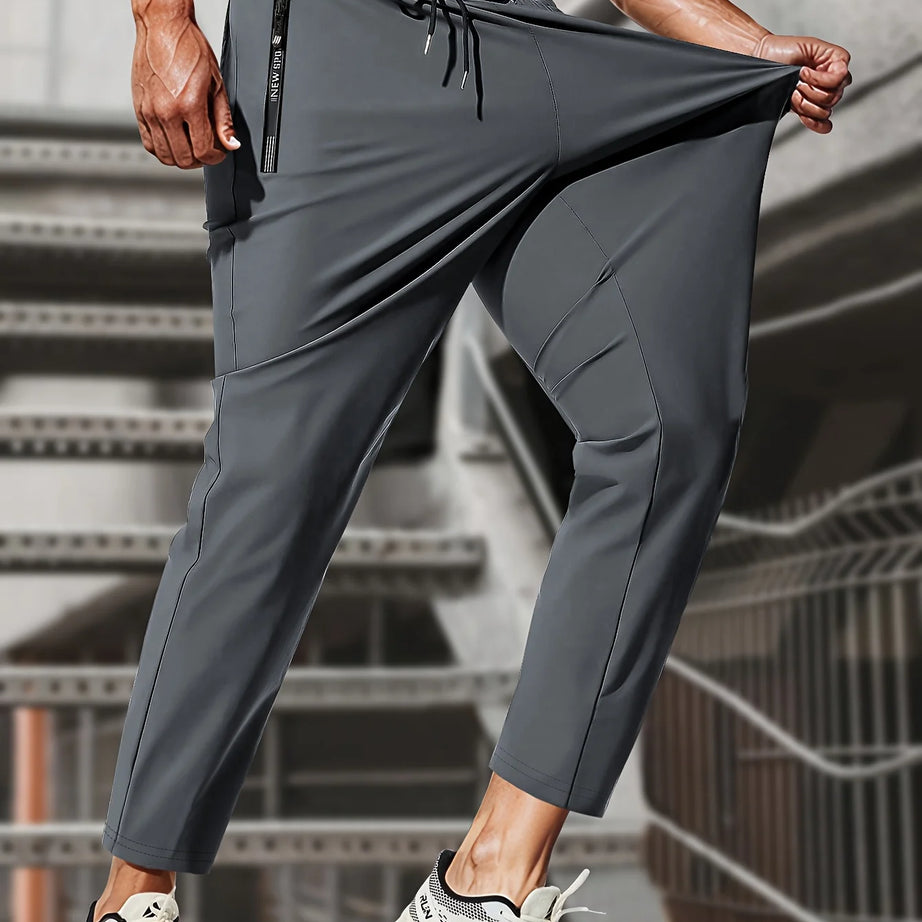 Pantalon de jogging homme, idéal pour la pêche. Modèle en soie glacée extensible avec poches zippées. Pantalon de sport respirant et élastique. Idée cadeau pour homme.