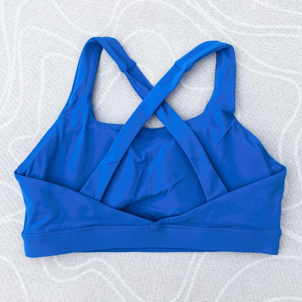 Soutien-gorge de sport et de fitness femme, couleur unie, moulant, dos croisé, idéal pour le yoga et la gym. Haut de sport avec dos ajouré et coussinets push-up.