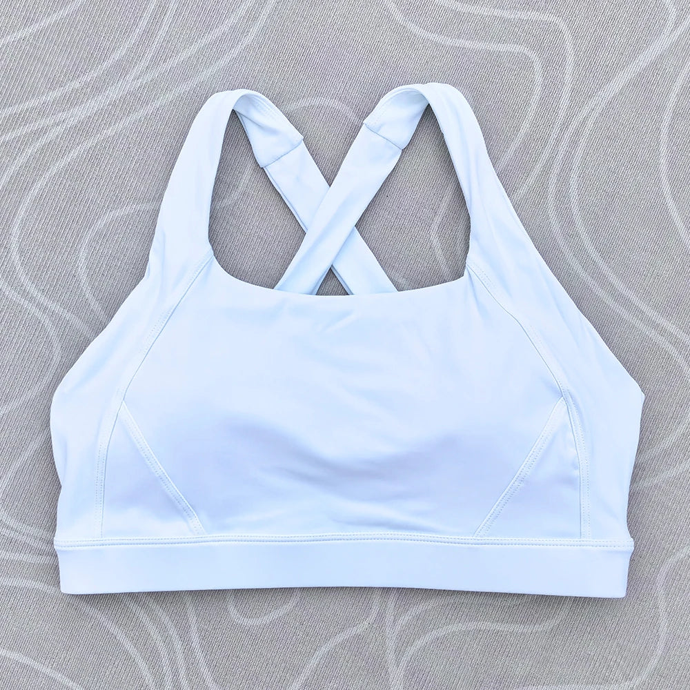 Soutien-gorge de sport et de fitness femme, couleur unie, moulant, dos croisé, idéal pour le yoga et la gym. Haut de sport avec dos ajouré et coussinets push-up.
