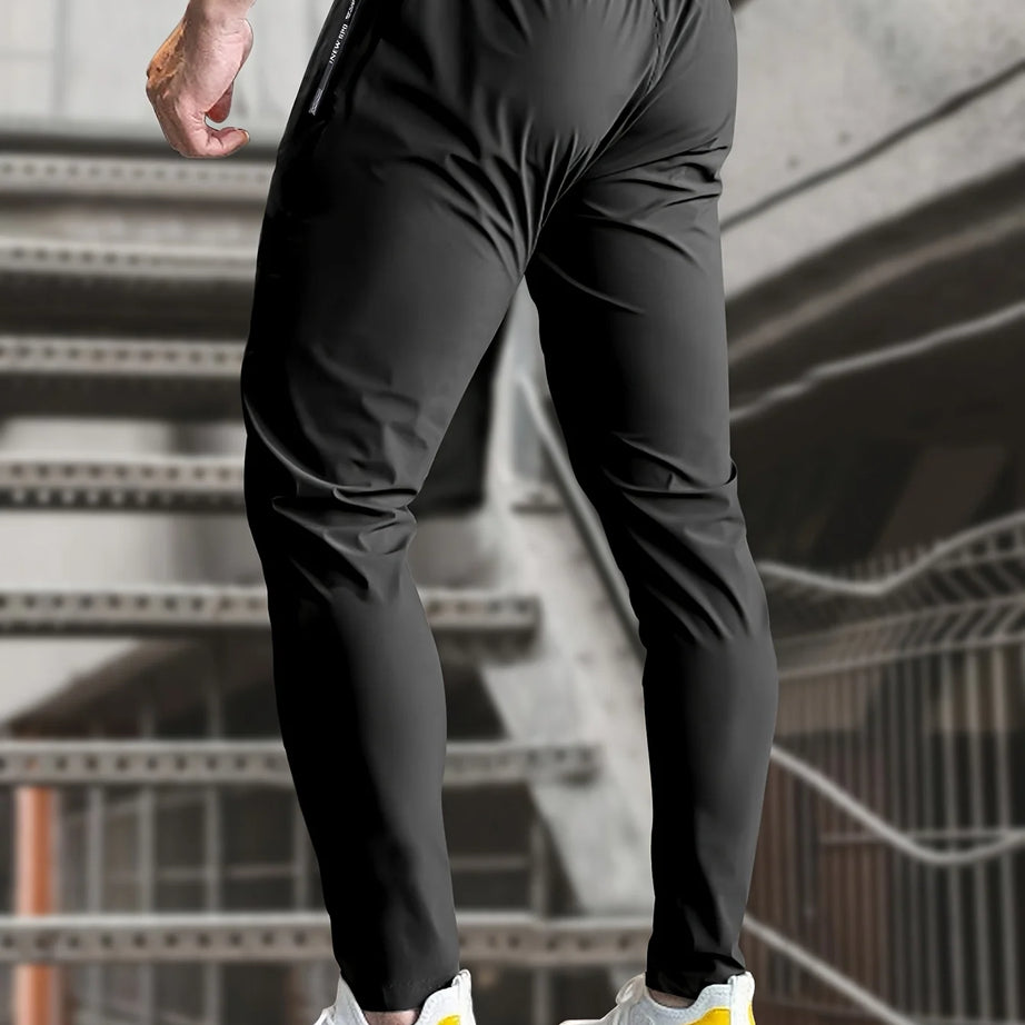 Pantalon de jogging homme, idéal pour la pêche. Modèle en soie glacée extensible avec poches zippées. Pantalon de sport respirant et élastique. Idée cadeau pour homme.