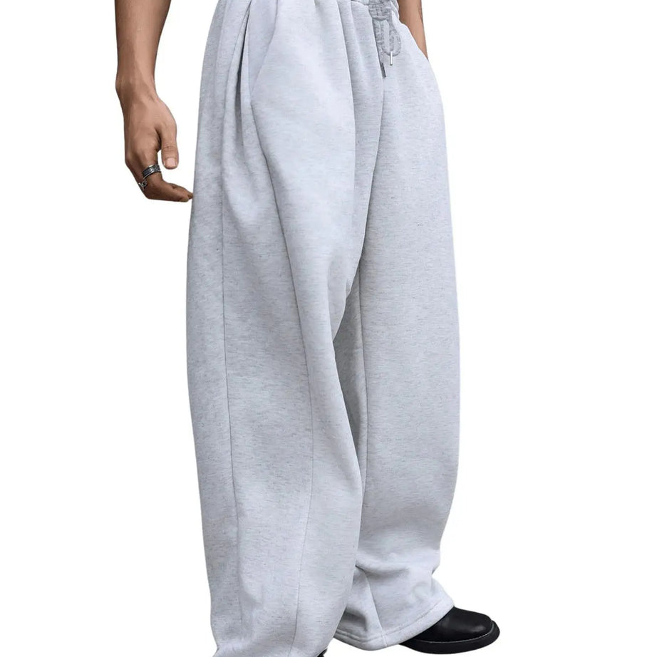 Pantalon de jogging pour homme, coupe droite, idéal pour le sport et la mode urbaine. Pantalon ample et décontracté avec cordon de serrage et plusieurs poches.