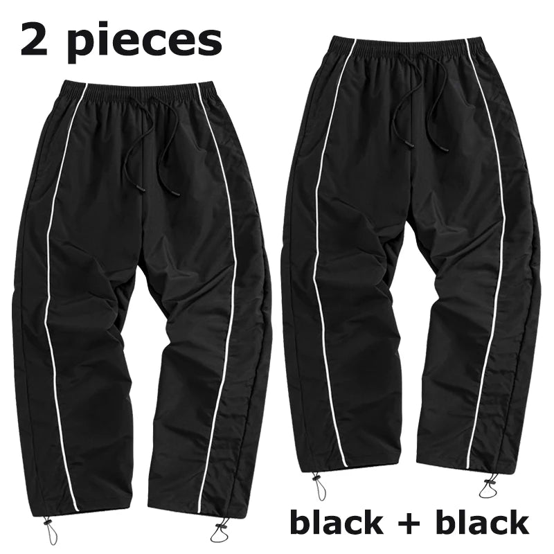 Pantalon de sport tendance pour homme, avec lignes, idéal pour la salle de sport et la course à pied. Poches latérales, séchage rapide et respirant.