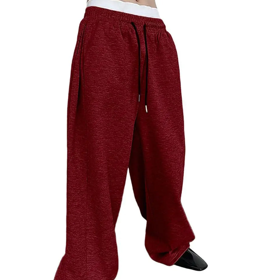 Pantalon de jogging pour homme, coupe droite, idéal pour le sport et la mode urbaine. Pantalon ample et décontracté avec cordon de serrage et plusieurs poches.