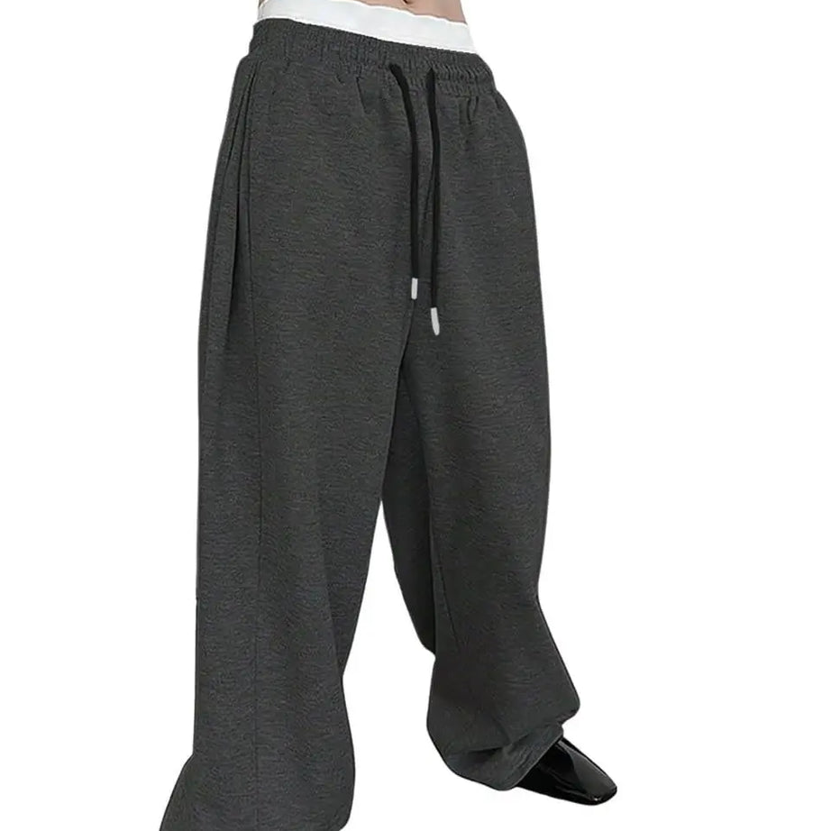 Pantalon de jogging pour homme, coupe droite, idéal pour le sport et la mode urbaine. Pantalon ample et décontracté avec cordon de serrage et plusieurs poches.