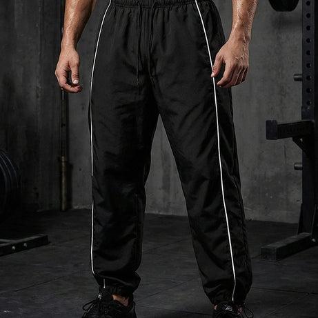 Pantalon de sport tendance pour homme, avec lignes, idéal pour la salle de sport et la course à pied. Poches latérales, séchage rapide et respirant.