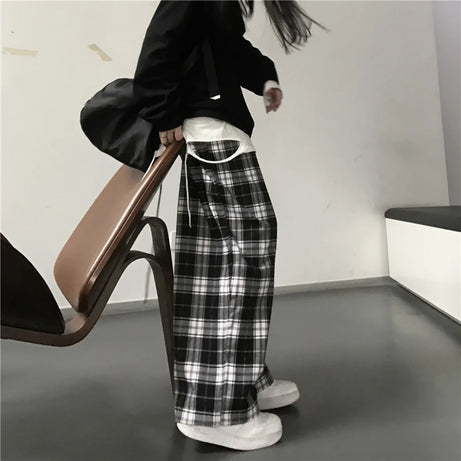 Pantalon de survêtement oversize pour femme, style tendance, à carreaux noirs, coupe ample, taille élastique, poches, style hip-hop unisexe, coupe ample.