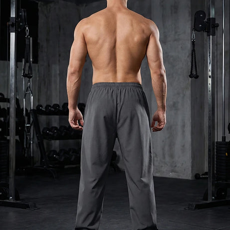 Pantalon de sport tendance pour homme, avec lignes, idéal pour la salle de sport et la course à pied. Poches latérales, séchage rapide et respirant.