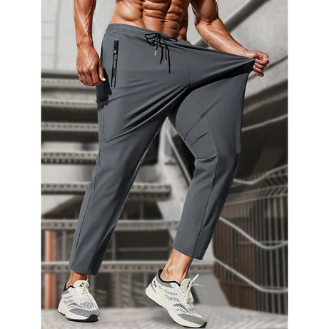 Pantalon de jogging homme, idéal pour la pêche. Modèle en soie glacée extensible avec poches zippées. Pantalon de sport respirant et élastique. Idée cadeau pour homme.
